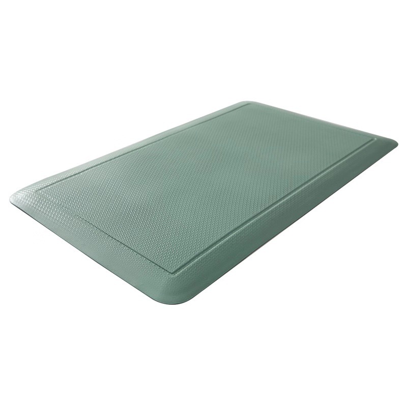 A green rubber comfort mat on a white background