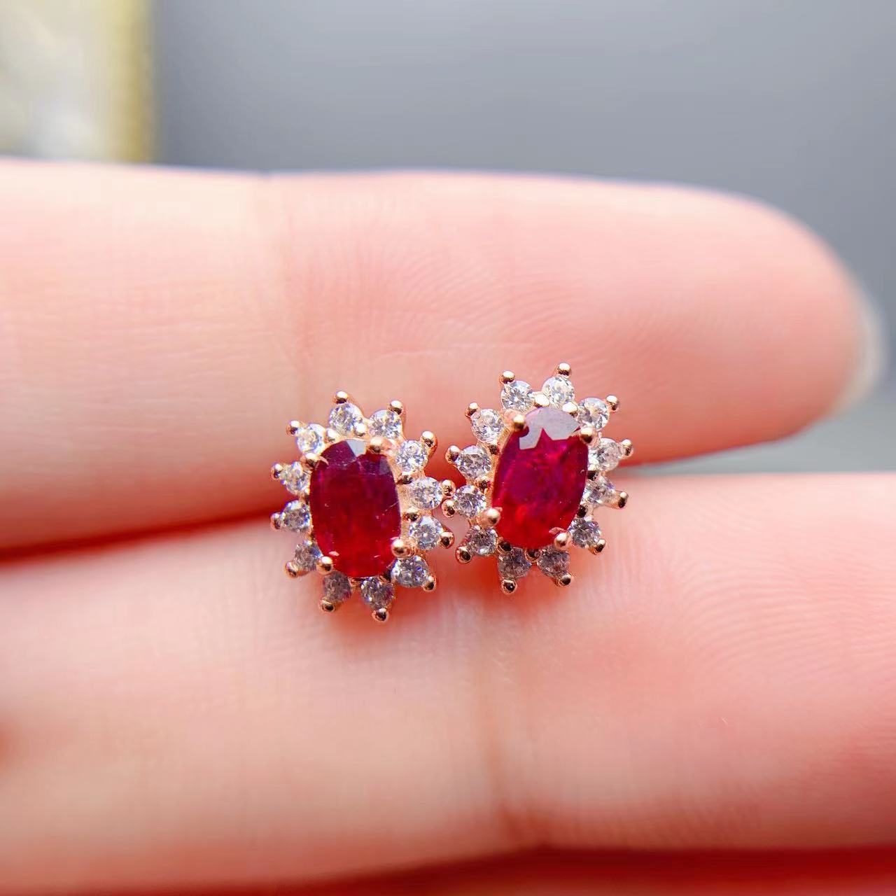 Silver Stud Earrings with Ruby on display