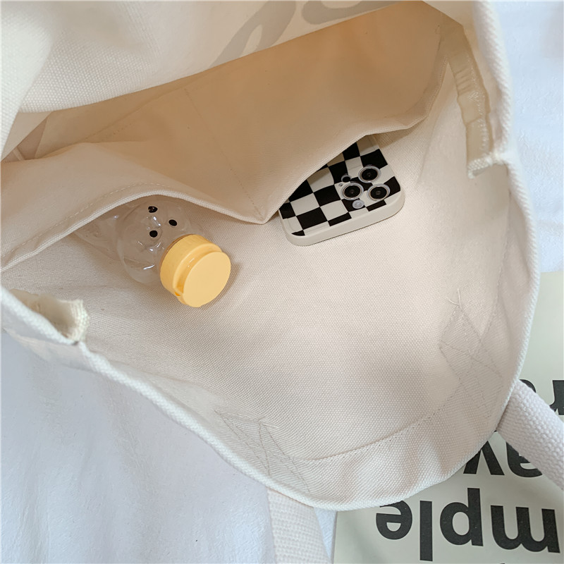 2c668faa fa11 4aa4 b8a9 089d4dd08955 - Solid color letter cloth pocket shoulder bag
