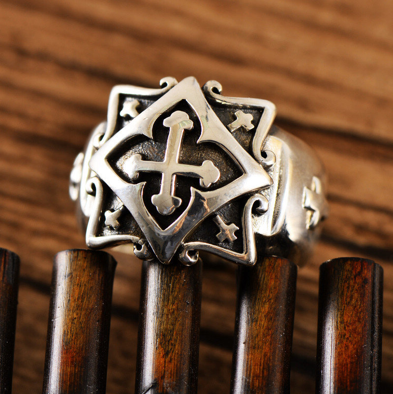 Close-up of a men's silver cross ring