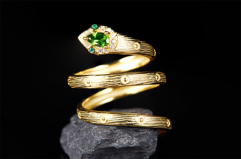 "Detail of a ring with a green gemstone"