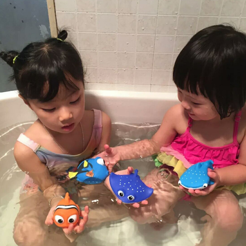 "Children playing with colorful bathtub toys"