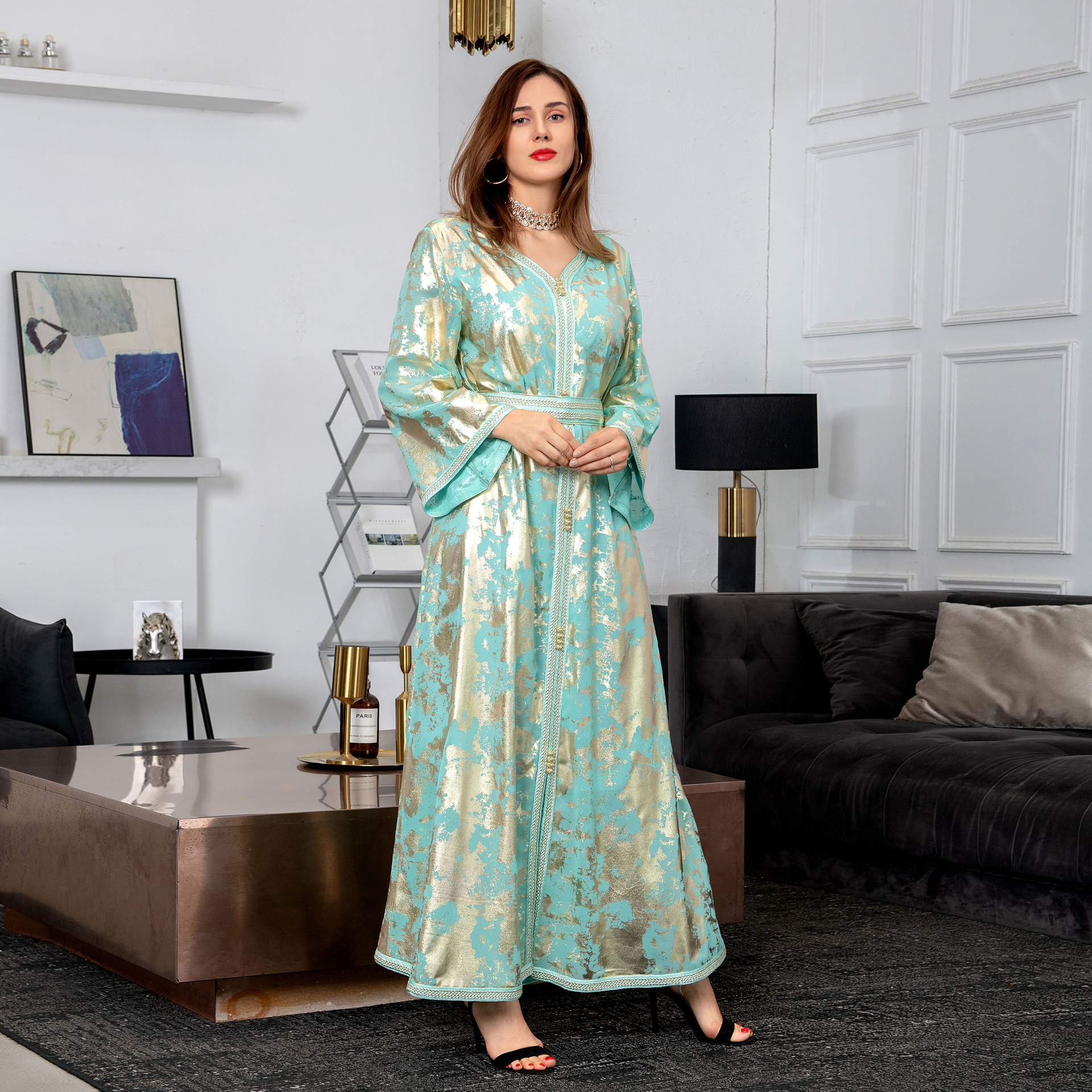 a woman wearing a green arabic gilded robe women's two-piece set full length view