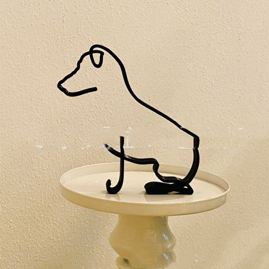 With its sleek and modern design, this dog minimalist art sculpture adds a touch of sophistication to any room, while also serving as a beautiful representation of man's best friend. The iron sculpture is characterized by clean lines, simple forms, and a focus on the essentials, creating a minimalist and abstract representation of a dog.